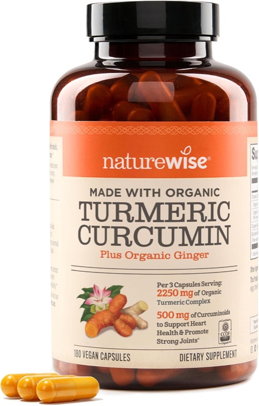 Elegantné balenie NatureWise Turmeric Curcumin 2250mg + BioPerine na drevenom stole s kurkumou a čiernym korením